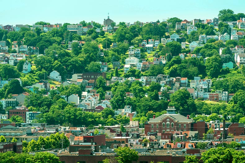 View of a hillside covered in houses, building, and trees in South Side Pittsburgh, Pennsylvania