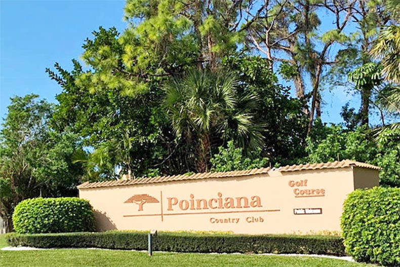 Greenery surrounding the community sign for Poinciana in Lake Worth, Florida