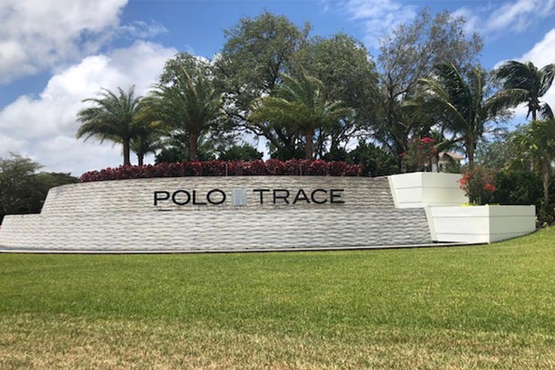 Palm trees surrounding the community sign for Polo Trace in Delray Beach, Florida