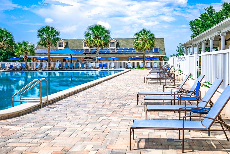 View of an outdoor pool and patio at On Top of the World in Ocala, Florida