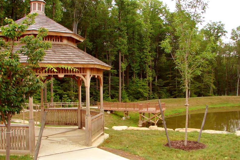 View of a gazebo and pier in front of a wooded area in Princeton Manor, located in Kendall Park, New Jersey