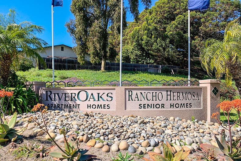 Rocks and greenery surrounding the community sign for Rancho Hermosa in Oceanside, California