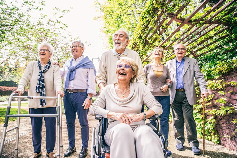 Residents of a nursing home enjoying a walk on the grounds