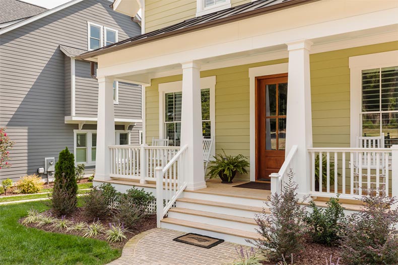 Exterior view of a nice house with a front porch and front lawn