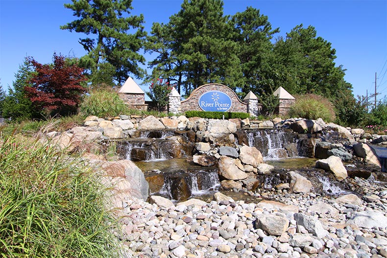 A small waterfall in front of the community sign for River Pointe in Manchester, New Jersey
