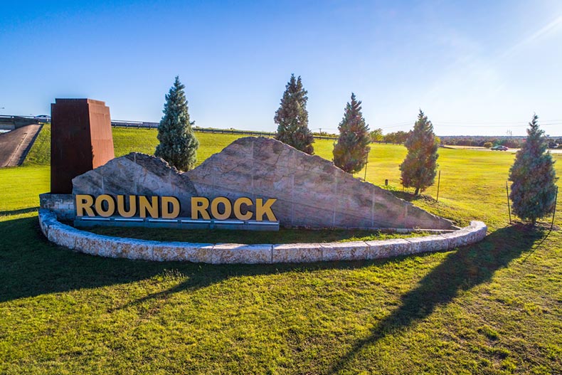 Trees around the welcome sign to Round Rock, Texas