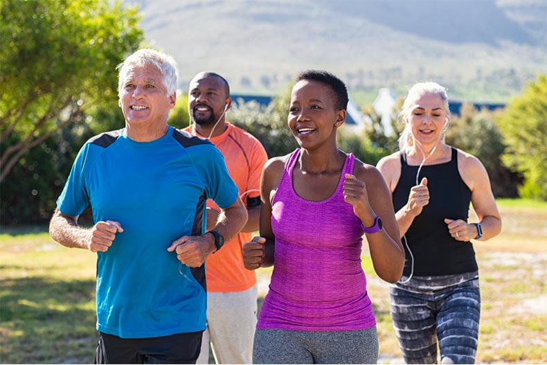 Group of older adult running in mountain landscape