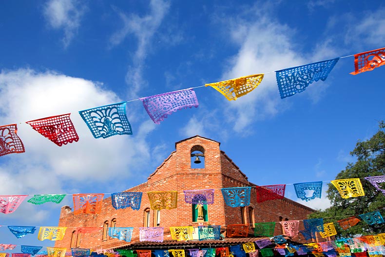 Colorful flags on banner strings in front of a Market Square building in San Antonio, Texas