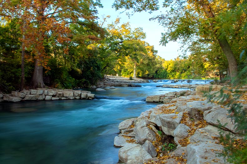 Rio Vista Park river flowing over rocks during autumn in San Marcos, Texas