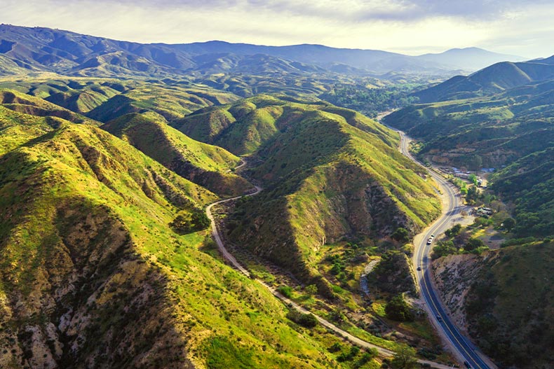 Aerial view of roads cutting through valleys in a Santa Clarita mountain range
