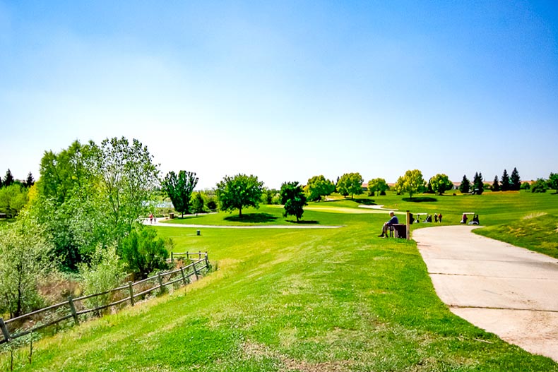 Wide shot of a pathway winding through a greenspace and golf course in Sun City Lincoln Hills, Lincoln, California