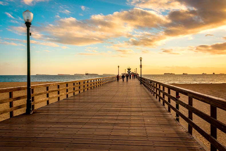 View down a pier leading to the Pacific Ocean in Seal Beach, California