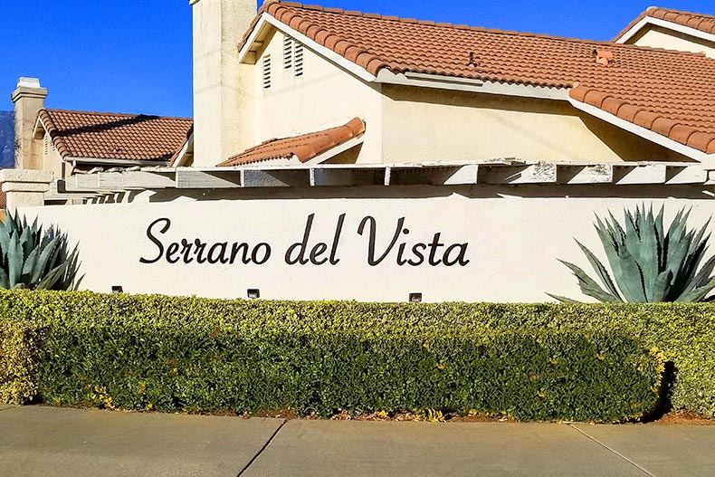 Shrubs in front of the community sign for Serrano Del Vista in Banning, California