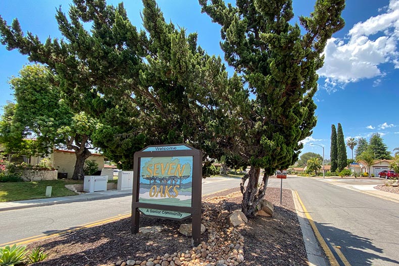 A tree behind the community sign for Seven Oaks in San Diego, California