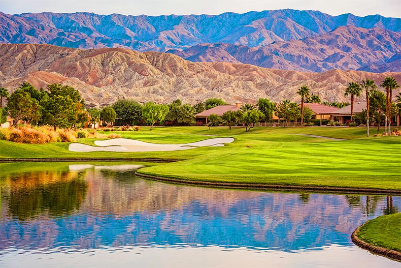 Shadow Hills Golf Course and pond backing up to a mountain range, located in Indio, California