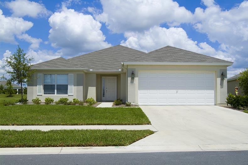 Exterior view of a single-story home with a yard and a driveway