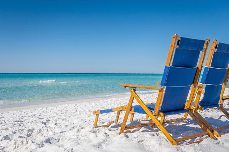 Lounge chairs on a white-sand beach