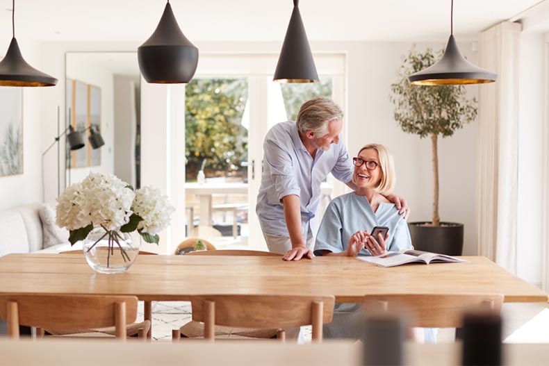 A snowbird couple smiling and relaxing in their home