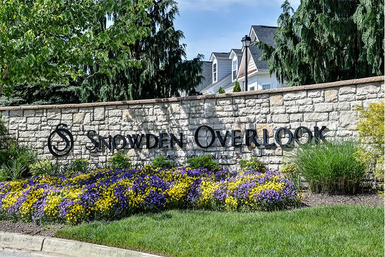 Greenery surrounding the community sign for Snowden Overlook in Columbia, Maryland