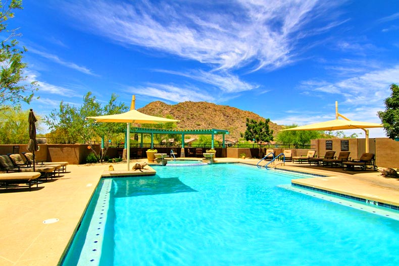A resort-style pool and patio with a mountain in the background, located in Solera at Johnson Ranch in Queen Creek, Arizona