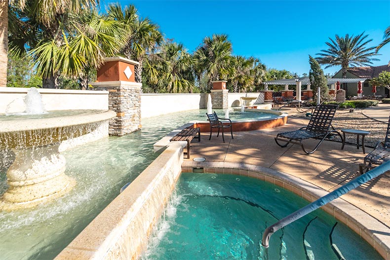 Palm trees surrounding the outdoor spa and patio at Solivita in Kissimmee, Florida