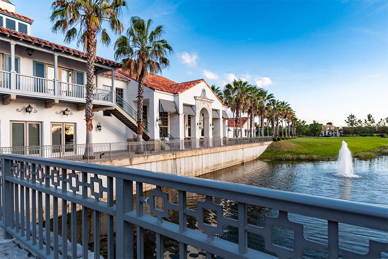 Palm trees lining a walkway outside a community building at Solivita in Kissimmee, Florida