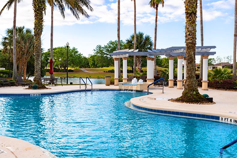 Palm trees and water features surrounding the outdoor pool at Solivita in Kissimmee, Florida
