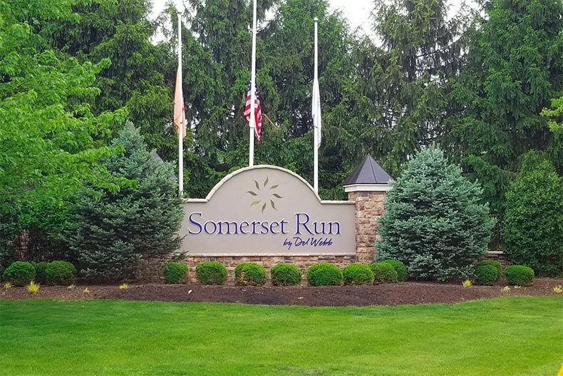 Trees surrounding the community sign for Somerset Run in Somerset, New Jersey