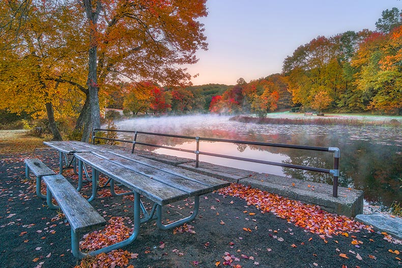 Photo of a bench and lake at Southford Falls State Park in Southbury, Connecticut