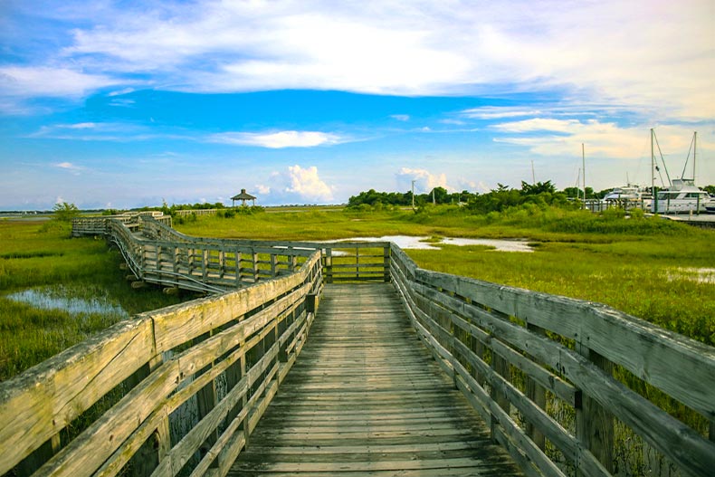 View down a boardwalk over a marsh in Southport, North Carolina