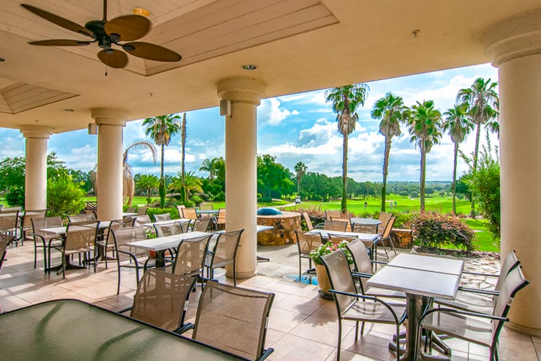 Tables and chairs on the outdoor patio at Spruce Creek Country Club in Summerfield, Florida