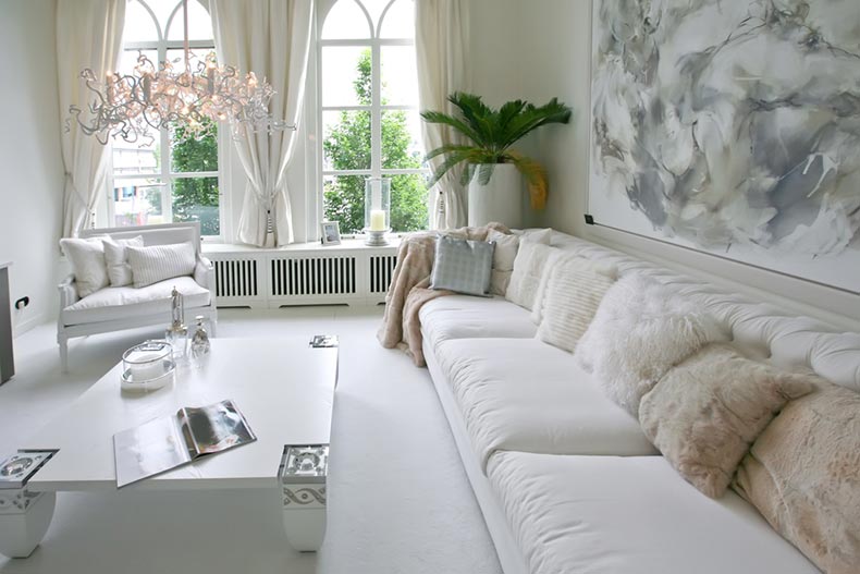 Interior view of a pristine home with white furniture and decorations