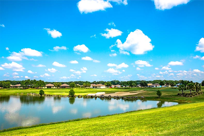 Houses at the edge of the golf course and pond on the grounds of Stone Creek in Ocala, Florida