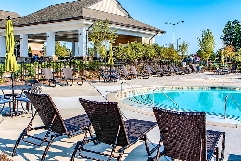 Lounge chairs surrounding the outdoor pool at Sun City Carolina Lakes in Indian Land, South Carolina