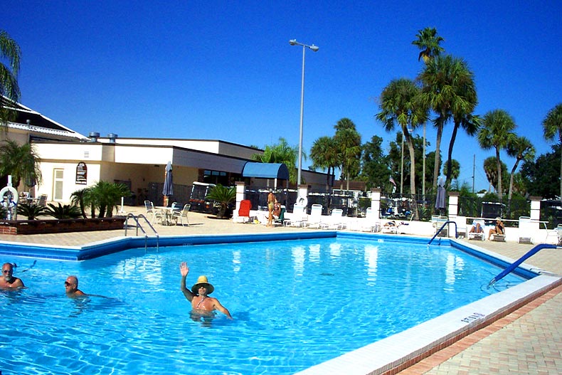 Sun City Center residents swimming in the outdoor pool in front of the clubhouse