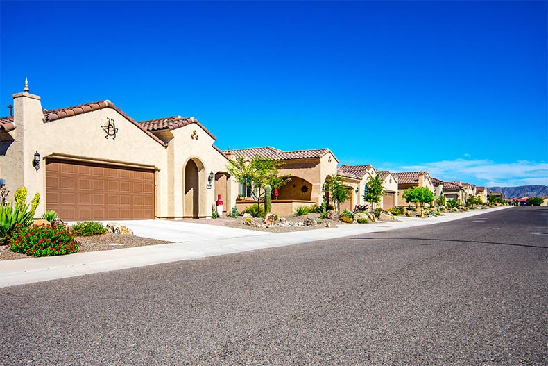 A row of homes down a street at Sun City Festival in Buckeye, Arizona