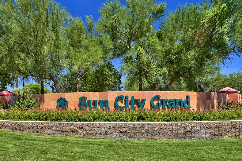 Greenery surrounding the community sign for Sun City Grand in Surprise, Arizona