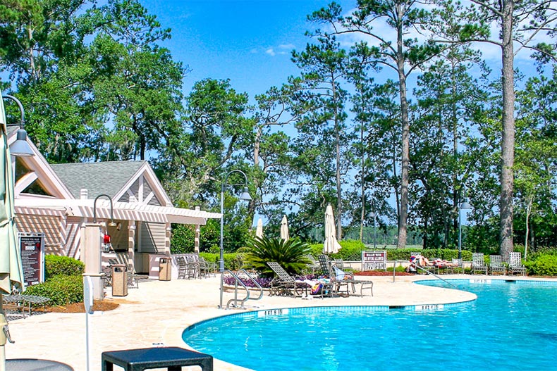 Lounge chairs beside the outdoor pool at Sun City Hilton Head in Bluffton, South Carolina