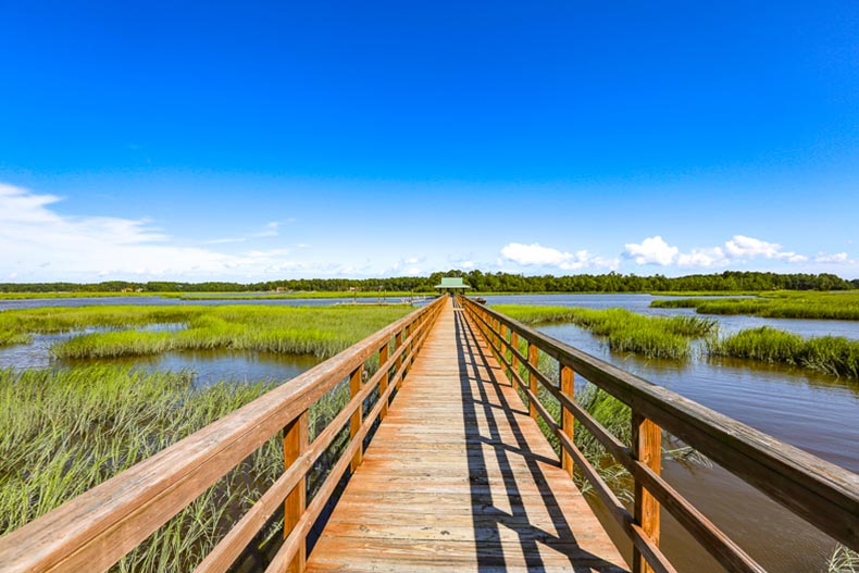 View down a boardwalk over marshes at Sun City Hilton Head in Bluffton, South Carolina