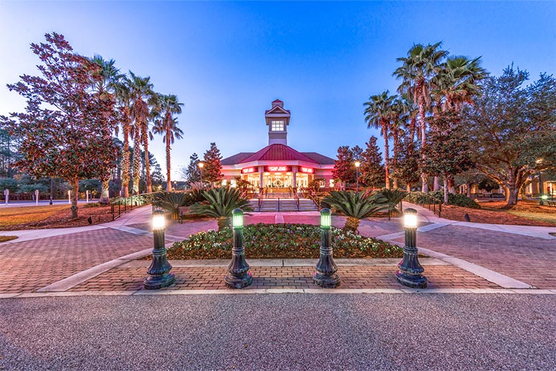 Twilight view of the trees and greenery surrounding the clubhouse at Sun City Hilton Head in Bluffton, South Carolina