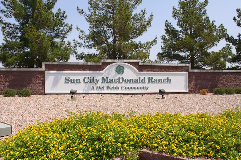 Greenery surrounding the community sign for Sun City MacDonald Ranch in Henderson, Nevada