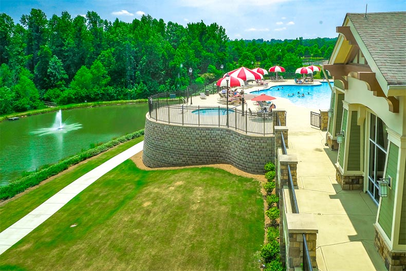Exterior view of the clubhouse, outdoor pool, patio, and spa at Sun City Peachtree in Griffin, Georgia