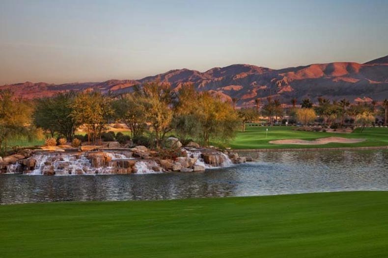 A picturesque waterfall and pond on the golf course at Sun City Shadow Hills in Indio, California