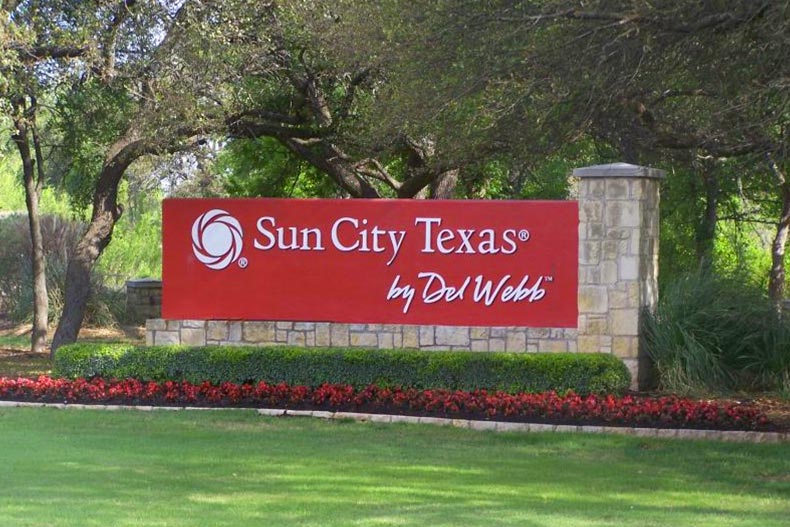 Greenery surrounding the community sign for Sun City Texas in Georgetown, Texas