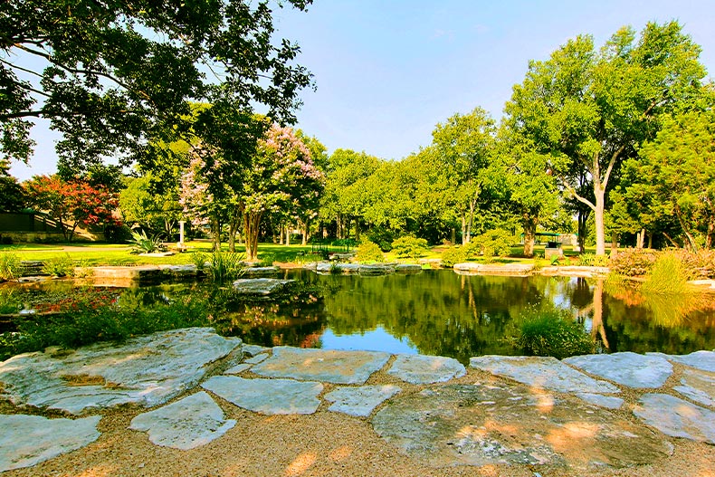 A pond surrounded by trees located in Sun City Texas of Georgetown, Texas