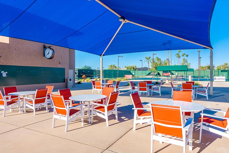 Chairs and tables beside the tennis courts at Sun City West in Sun City West, Arizona