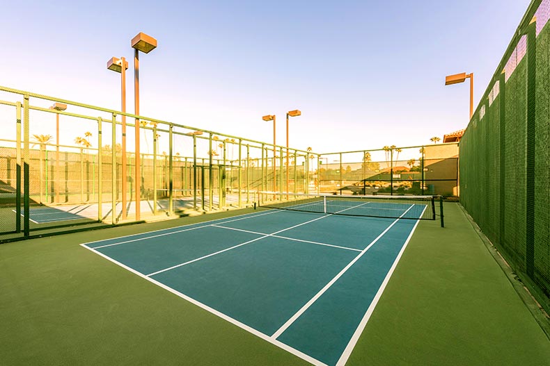 A single blue tennis court in a gated tennis center located in Sun City West in Surprise, Arizona