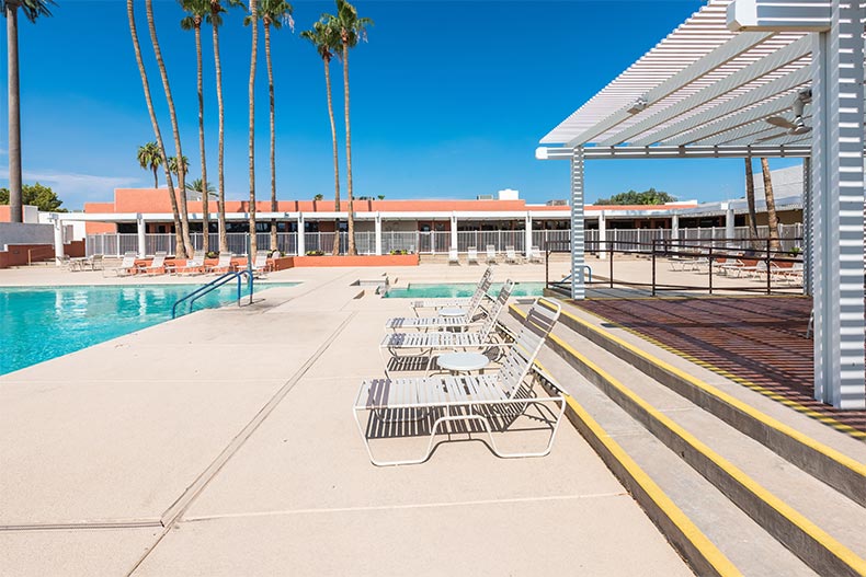 Lounge chairs beside the outdoor pool at Sun Lakes Country Club in Banning, California