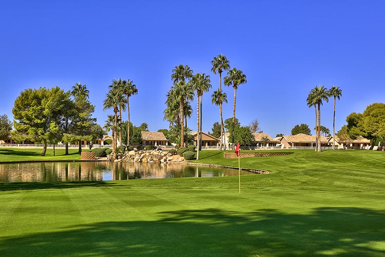 View of the golf course and a pond in Sun Village, located in Surprise, Arizona