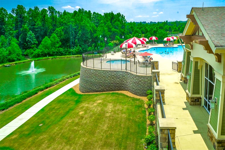 Resort-style pool next to pond outside Club Peachtree at Sun City Peachtree in Georgia